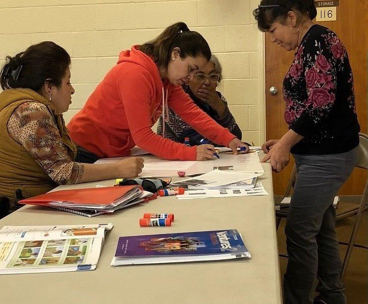 Adult education students working at a table